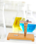 Wooden inertia demonstrator pendulum with beakers, for science classroom teaching and Newtonian mechanics experiments tool.
