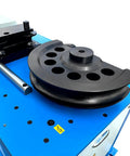 Heavy Duty Programmable Electric Hydraulic Tube And Pipe Bender Featuring Programmable Logic Controller Seven Horsepower Motor Includes Three And Two Point Three Eight Inch Dies Quick Swap Auto Or Manual Modes Bends Up To One Eighty Degrees Tough As Nails, close-up of die and bender mechanism.