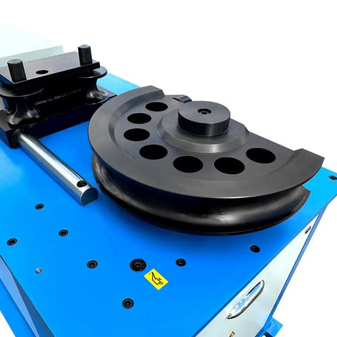 Heavy Duty Programmable Electric Hydraulic Tube And Pipe Bender Featuring Programmable Logic Controller Seven Horsepower Motor Includes Three And Two Point Three Eight Inch Dies Quick Swap Auto Or Manual Modes Bends Up To One Eighty Degrees Tough As Nails, close-up of die and bender mechanism.