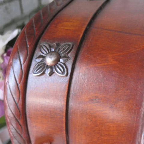 Close-up of a wooden surface featuring a vintage iron decorative tack, part of the 50 Pack Vintage Upholstery Nails Heavy Duty Iron Decorative Tacks For Furniture Makeover Rust Resistant Plated Surface Dead Simple Install Solid Grip Top Tier Craft Gear No Hassle Assembly.