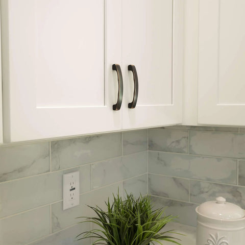 Solid Zinc Alloy Kitchen Cabinet Pull Handle in Oil Rubbed Bronze Simplicity Series installed on white cabinet doors.