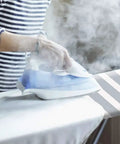 Person ironing on Beefed Up Heavy Duty Ironing Board Cover And Pad With Pull Bungee Fit System and Straps, four-layer silicone coated.