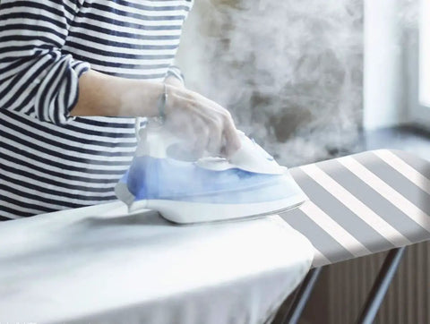 Person ironing on Beefed Up Heavy Duty Ironing Board Cover And Pad With Pull Bungee Fit System and Straps, four-layer silicone coated.