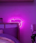 Cute Cat Neon Sign LED Light USB Powered Wall Art Decor with Pink and Blue Glow above bed in dimly lit kids room.