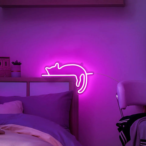 Cute Cat Neon Sign LED Light USB Powered Wall Art Decor with Pink and Blue Glow above bed in dimly lit kids room.