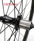 Close-up of beefy aluminum hub on 700C carbon fiber wheelset with 50mm fat rim for road bikes, rear 130mm quick release.