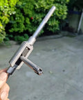 Hand holding a 10 Piece Screw Tap Extractor Set High Speed Steel Drill Tap Remover For Broken Heads And Stripped Screws outdoors.