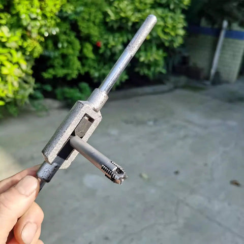 Hand holding a 10 Piece Screw Tap Extractor Set High Speed Steel Drill Tap Remover For Broken Heads And Stripped Screws outdoors.