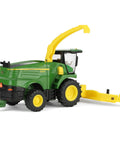 One Sixty Fourth Scale Farm Harvester Toy With Swiveling Spout Metal Frame And Body Plastic Forage Head Rear Hitch Realistic Five Inch Length Model For Kids Three And Up side view