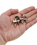 Person holding 5mm Shelf Support Pegs 50 Pack With Hole L Shaped Nickel Plated Pins for cabinets and shelves