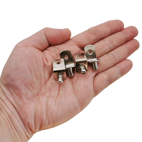Person holding 5mm Shelf Support Pegs 50 Pack With Hole L Shaped Nickel Plated Pins for cabinets and shelves