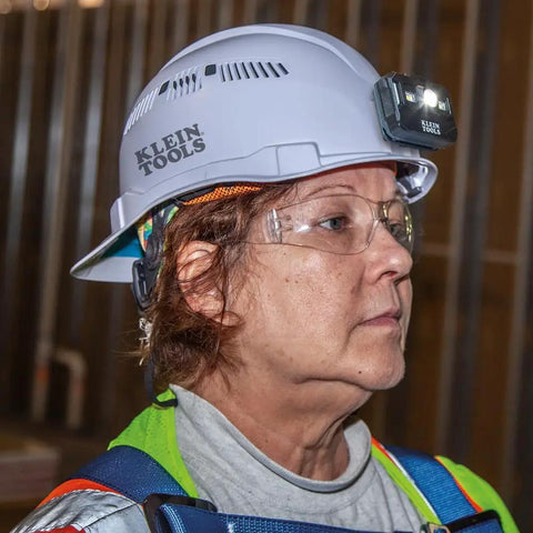 Side profile of a person wearing a white Hard Hat With Rechargeable Headlamp Mounts Front And Back Cap Style Vented Shell
