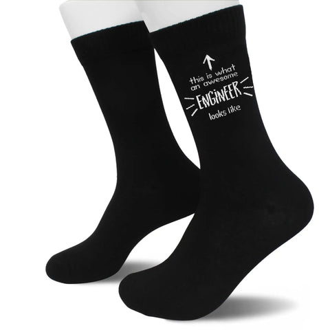 These Hilarious And Comfy Awesome Engineer Socks Are The Perfect Funny Gift Idea For Any Engineer Dude Or Dudette Looking For Unique Birthday Christmas Graduation Or Fathers And Mothers Day Presents. Black socks with white text design.