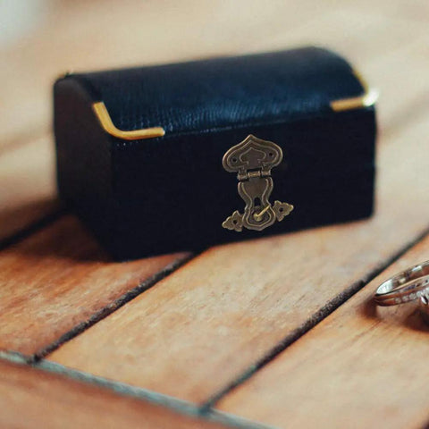 Chic Vintage Bronze Hasp Latch Clamp For Antique Wood Boxes on a black jewelry box with wooden background.
