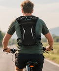 Cyclist wearing Hydration Vest Water Backpack For Running And Hiking Lightweight Reservoir Pack with breathable back panel