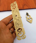Vintage Style Embossed Pattern Brass Pull Handle with Antique Bronze Finish, held by hand, suitable for bookcase and wardrobe doors.