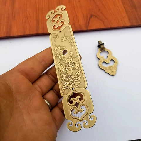 Vintage Style Embossed Pattern Brass Pull Handle with Antique Bronze Finish, held by hand, suitable for bookcase and wardrobe doors.