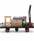 No Sweat Heavy Duty 2 In 1 Folding Hand Truck With Silent TPR Wheels And Detachable Steel Fence carrying boxes and a stool.