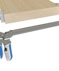 Slick Auto Adjust Bar Clamp For Woodworking And Diy Assembly Self Adjusting One Hand Press Tool Delivers Consistent Pressure Without The Hassle Precision Shop Essentials clamping a wooden plank.