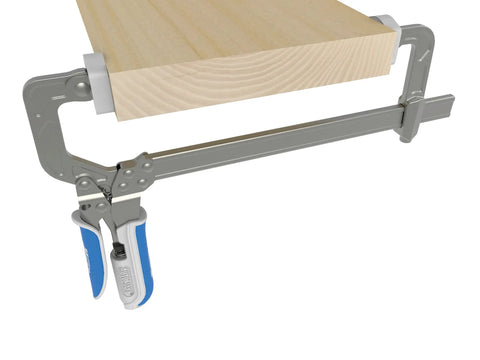 Slick Auto Adjust Bar Clamp For Woodworking And Diy Assembly Self Adjusting One Hand Press Tool Delivers Consistent Pressure Without The Hassle Precision Shop Essentials clamping a wooden plank.
