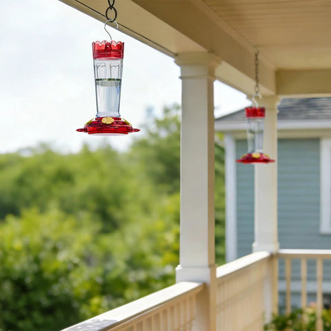 2 Pack 14 Ounce Plastic Hummingbird Feeders With Ant Moat And Bee Guard For Outdoors hanging on porch