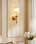 Modern Brass Wall Lamp With White Cotton Drum Shade Matte Warm Antique Finish Easy Install Sconce For Living Room Hallway And Decor Lighting Vibe Ideal For Bedrooms And Dining Areas installed in elegant room