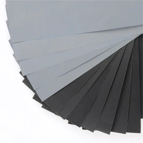 Get Fresh 100 Pc Assorted Wet Dry Sanding Sheets Sized At 9x3 8 Inch featuring gray and black smooth surfaces for polishing.