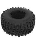 Close-up of a rugged off-road tire viewed from the side, showcasing tread design for durability and traction on rough surfaces.