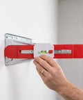 Adjustable Telescopic Spirit Level Ruler for Ac Installation, Red being used to level an AC bracket on a wall.