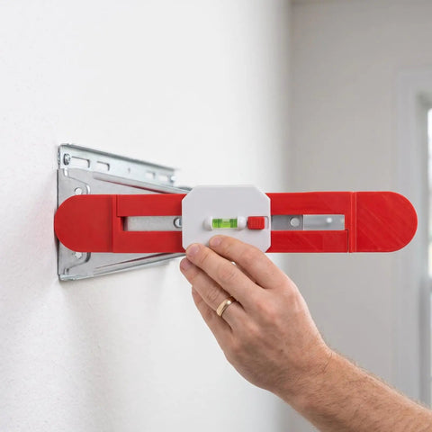 Adjustable Telescopic Spirit Level Ruler for Ac Installation, Red being used to level an AC bracket on a wall.