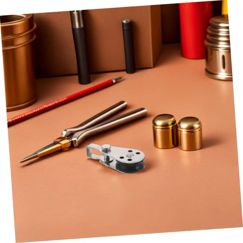 4pc Stainless Steel Pulley Blocks For Kayak And Boat Anchor on a brown desk with tools and metallic accents
