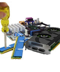 Hand holding a yellow screwdriver above computer components, including RAM and a graphics card.