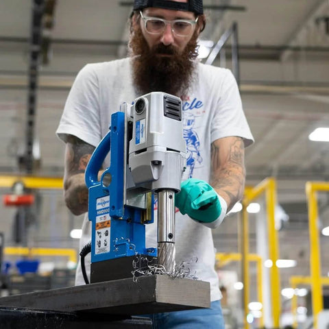 Front view of Hougen HMD900 magnetic drill, 115V, blue base with silver head in use on metal.