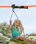 Child enjoying a ride on a backyard zipline with Silicone Zipline Brake Stopper for Slackline and Backyard Zipline Braking System Durable Stopper