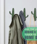 Roll With That Chill Southwest Vibe Using This Set Of Three Rustic Green Cast Iron Cactus Wall Hooks holding a jacket and bag.