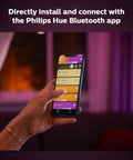 Hand controlling Gold Smart Table Lamp With White And Color Ambiance LED That Changes Color via smartphone app