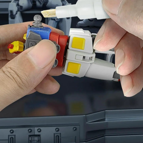 Applying Action Figure Joint Reinforcement Glue Pen For Model Kits Toy Repair Adhesive Quick Cure Formula to stabilize limbs.