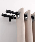 Installed view of the Three Piece Adjustable Curtain Rod Brackets Set With Double Wall Mount Holders holding beige curtains, durable black finish.
