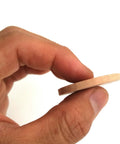 Hand holding a Solid Quality Natural Wood Round Unfinished Craft Disc, ideal for DIY projects and rustic decor.