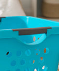 Close-up of teal laundry basket handle with ventilation holes, part of Deep 30L Laundry Basket Hamper Organizer With Built In Comfort Carry Handles So Handy Ventilated Nestable Design 2 Pack Medium Teal Ideal For Closet Dorm Laundry Room And Bedroom Storage
