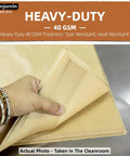 Person holding a stack of Bulk Unbleached Parchment Paper Sheets for 8x8 Baking Pans Heavy-Duty Nonstick FDA And LFGB Safe