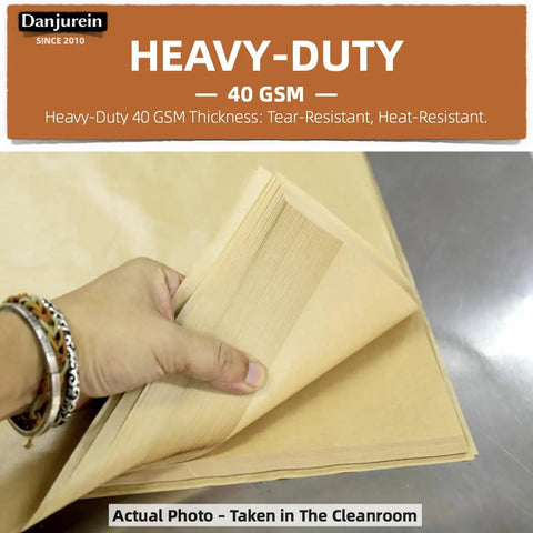 Person holding a stack of Bulk Unbleached Parchment Paper Sheets for 8x8 Baking Pans Heavy-Duty Nonstick FDA And LFGB Safe