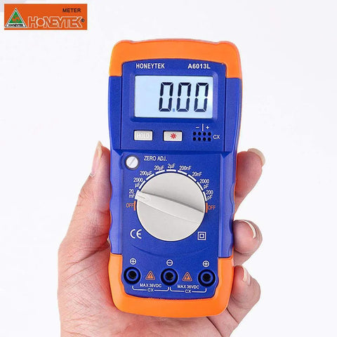 Handheld Capacitance Meter With LCD Backlight And Data Hold 1999 Count Display Measures 200 pF To 20 mF High Accuracy Pro Grade Portable Lab Tool For The Workshop Factory Or Home Testing Workhorse, blue-orange handheld meter in hand