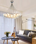 Polished Chrome And Distinctive Glass Pendant Ceiling Light With Energy Efficient Led Bulbs illuminating a modern living room.