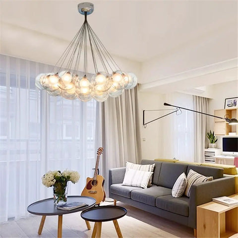 Drop Dead Stunning Modern Glass Pendant Chandelier With Polished Chrome Finish And Efficient Led G4 Bulbs over a cozy living room.