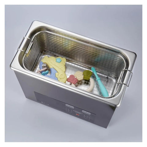 Industrial Ultrasonic Cleaner With Digital Display And Six Liter Tank containing cleaning toys in a stainless steel basket.