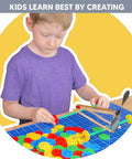 Bulk 100 Pack Small Plastic Wheels For Crafts And STEM Projects, Ideal For DIY Cars, Classroom Activities, And Craft Projects, Includes 4 Colors (25 Each), Durable Toy Wheels For Prototyping And Learning. Boy using small plastic wheels for a DIY car craft project
