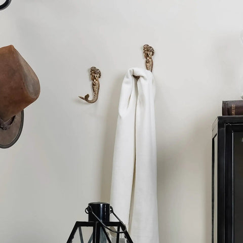 Mermaid Shaped Metal Wall Hooks Set Of 2, Beachy Coastal Decor Wall Mounted Coat Racks For Keys Towels Clothes Scarves And Bags, Antique Aqua Finish Now, holding a white towel on a wall.