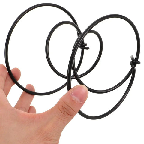 Rock Solid Heavy Duty Tension Springs 4 Pack Sofa Replacement Parts Fix Couch And Recliner Fast High Strength Steel Clip Kit For Bed Frame Repair Built Tough 3.93 Inch Super Durable Support Boost, black steel springs in hand.