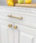 10 Pack Champagne Bronze Cabinet Pulls 5 Inch Center To Center installed on white kitchen cabinets with smooth edges